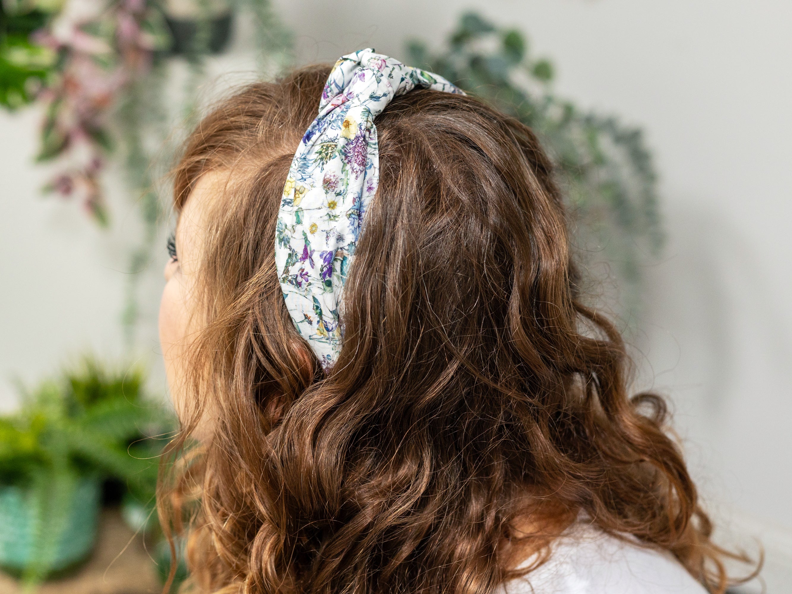 A Model Wearing A Classic Knot Headband, Liberty London Wild Flowers Print | Holme & Moss