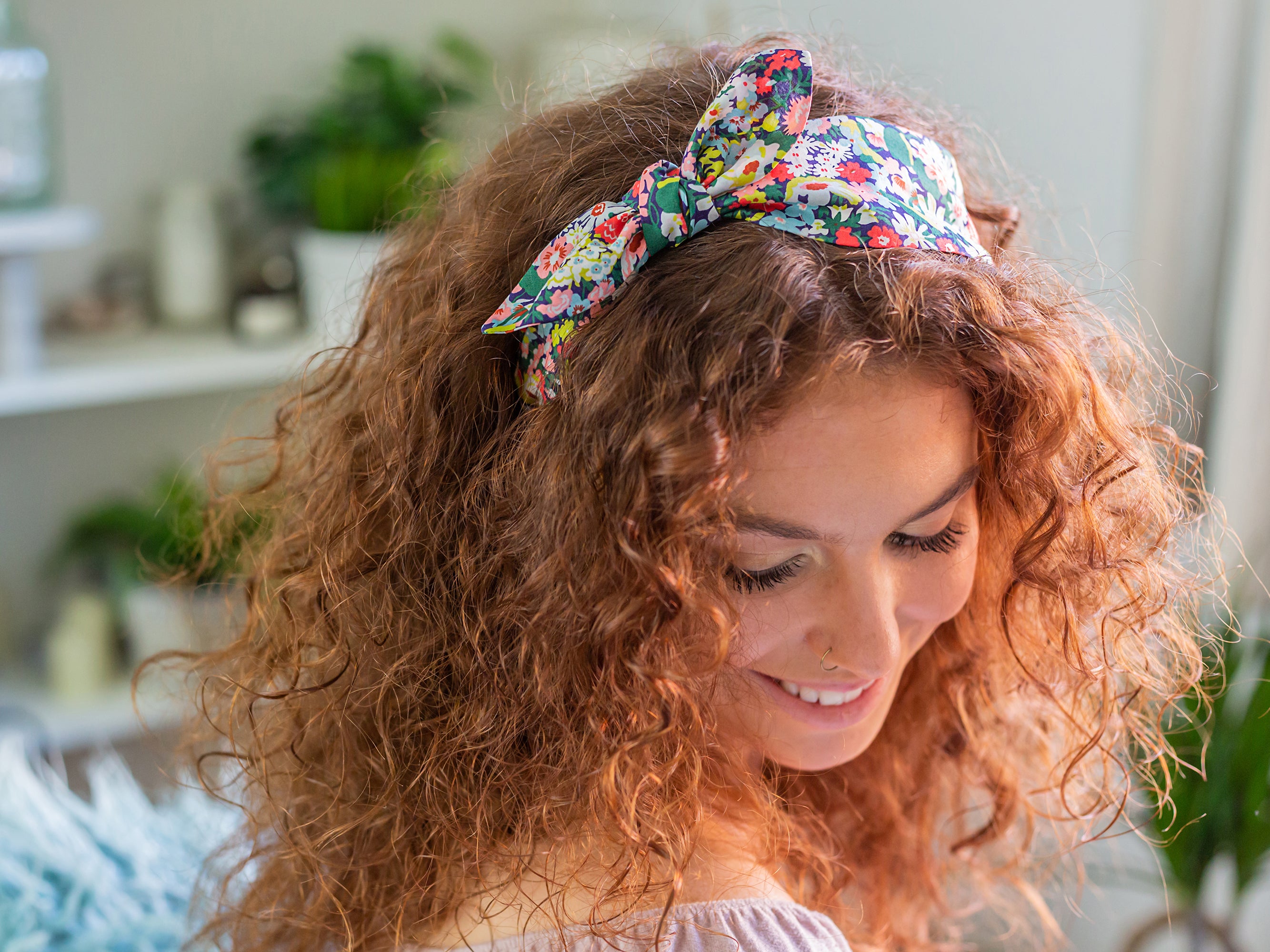 A woman wearing a Liberty London print side bow headband | Holme & Moss