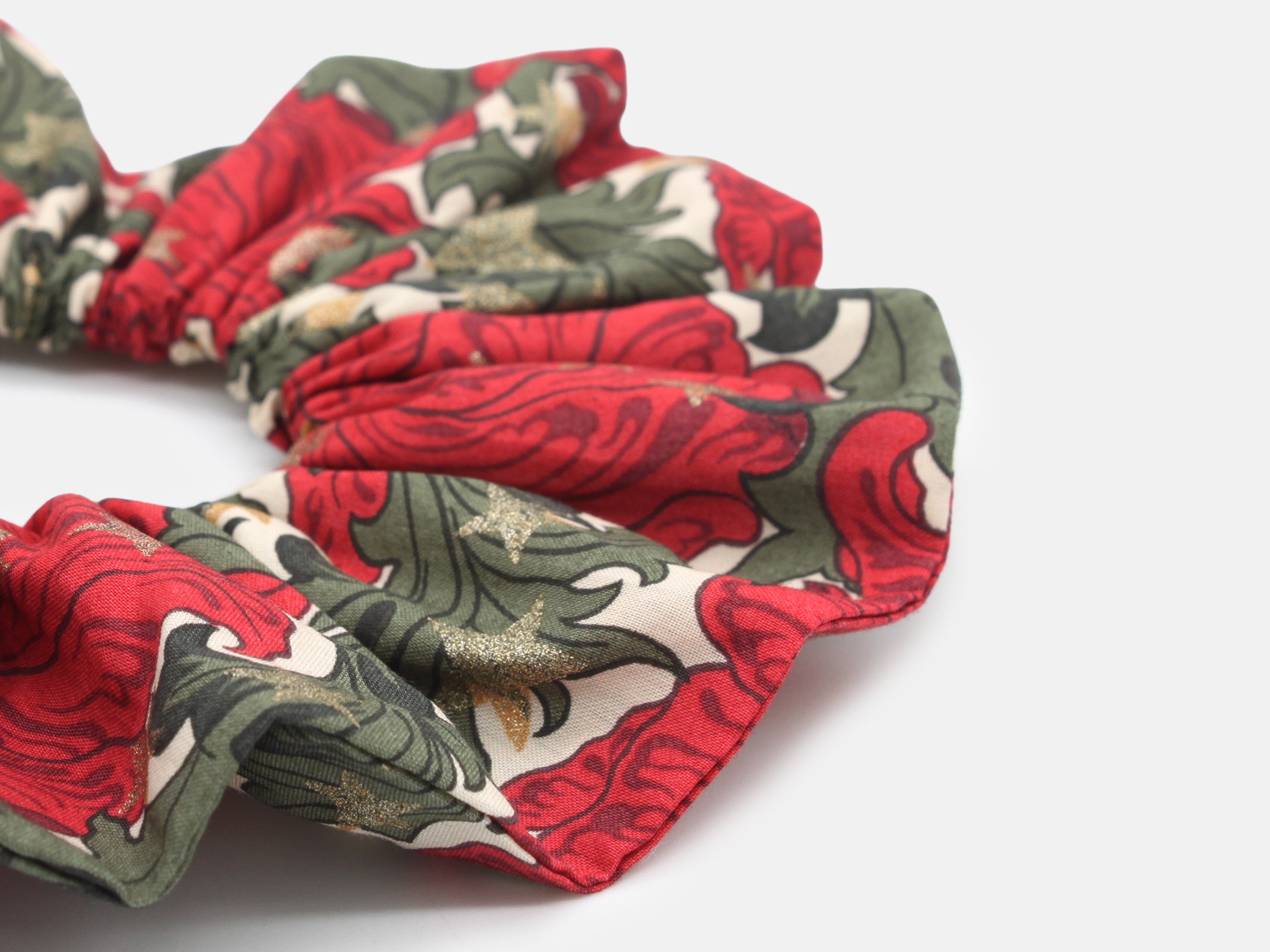 Festive Liberty print scrunchie in rich red and green, scattered with shimmering gold stars | Large scrunchie close-up - Liberty Merry Reverie Print | Holme & Moss