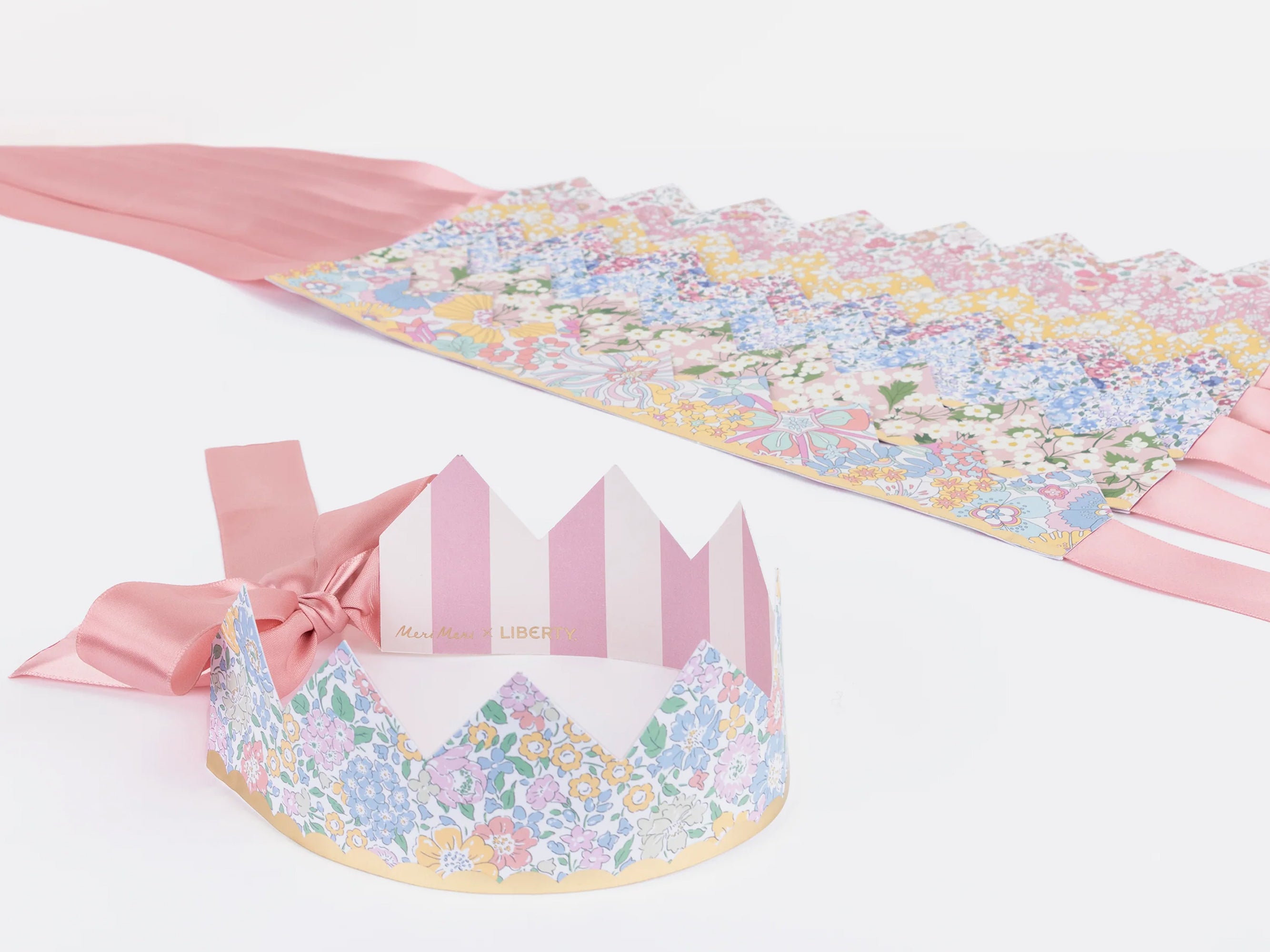 Decorative paper crowns with Liberty floral patterns and pink ribbons on a white background | Meri Meri x Liberty Party Crowns (8) | Holme & Moss