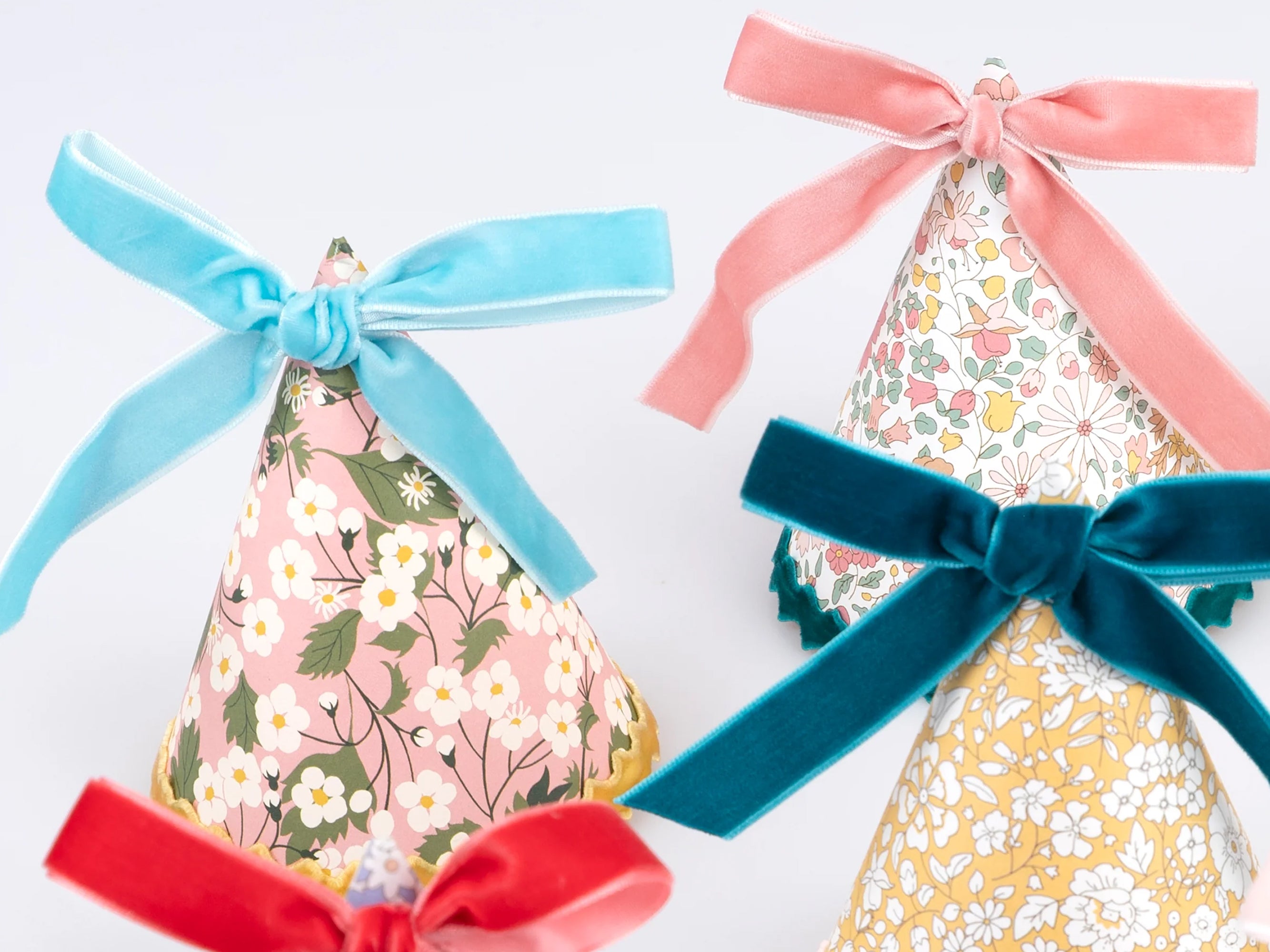 Decorative party with colourful velvet ribbons on a white background | Meri Meri x Liberty 8 Party Hats | Holme & Moss