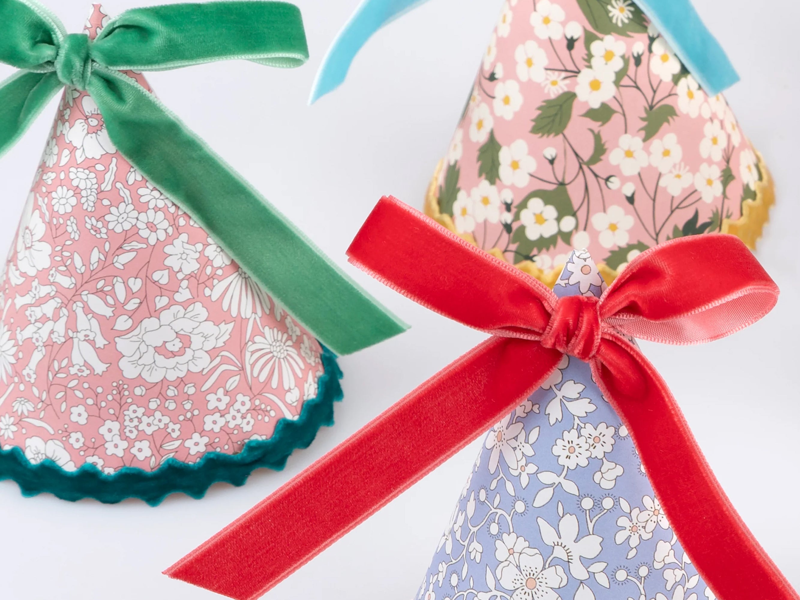 Decorative party with colourful velvet ribbons on a white background | Meri Meri x Liberty 8 Party Hats | Holme & Moss