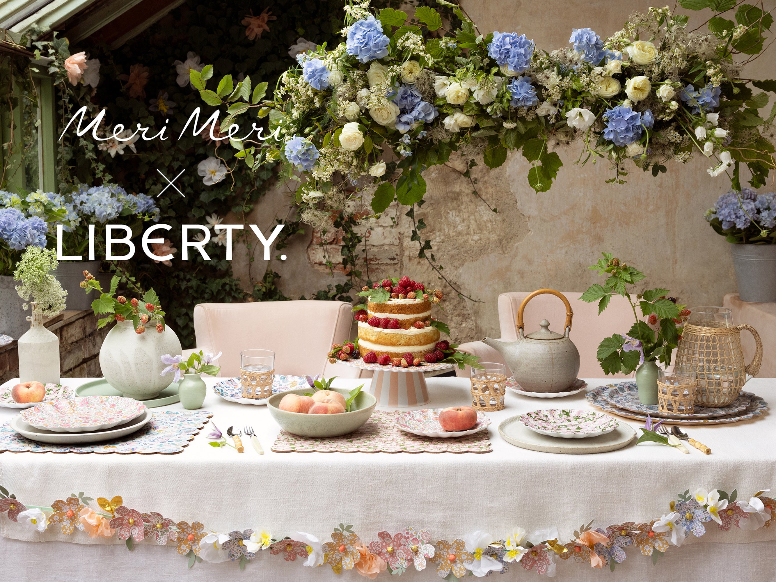 Decorative table setting with flowers and tableware, featuring Meri Meri x Liberty branding | Meri Meri x Liberty Reusable Cake Stand | Holme & Moss