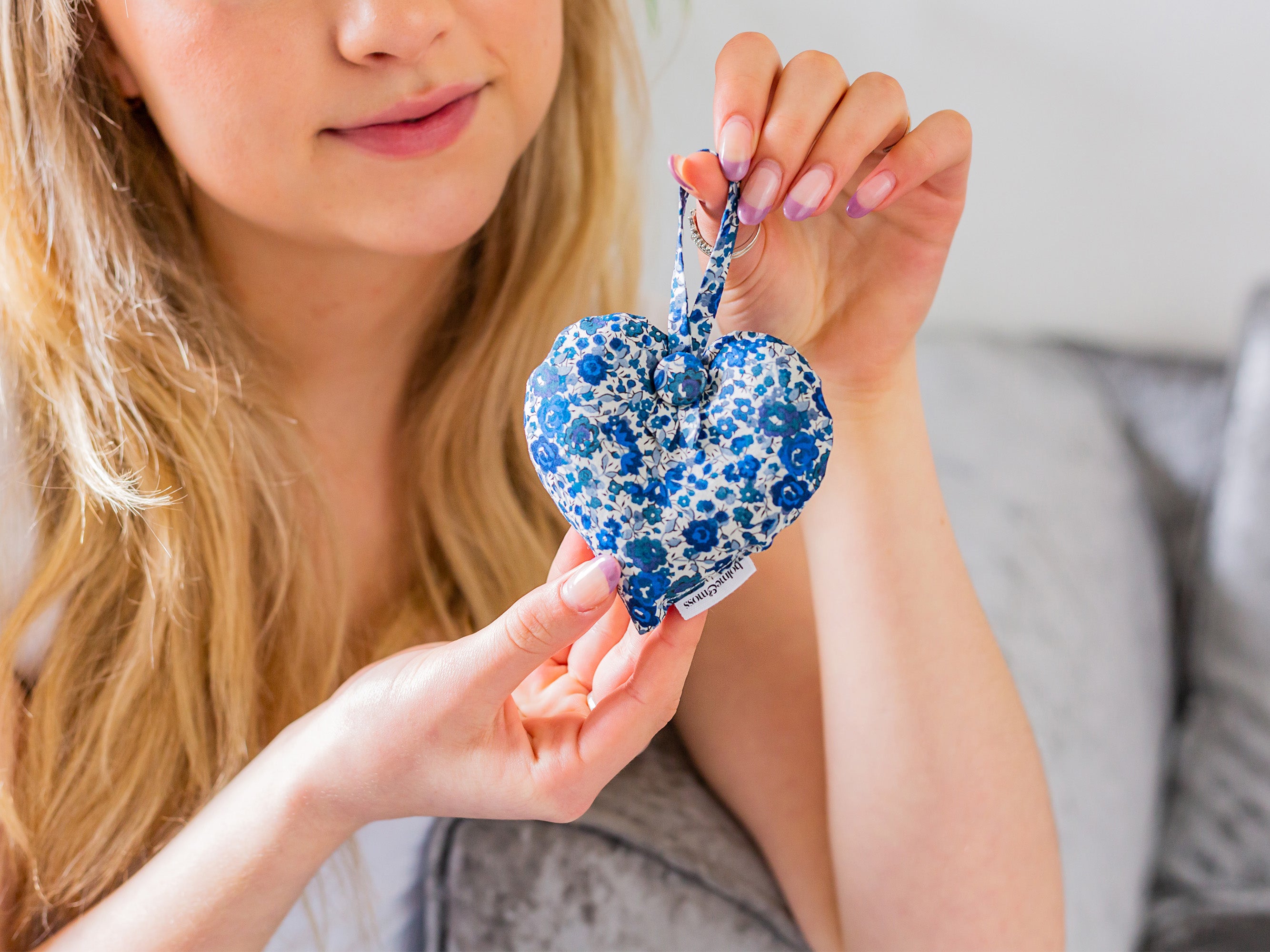 Woman holding a Liberty print lavender Heart | Holme & Moss