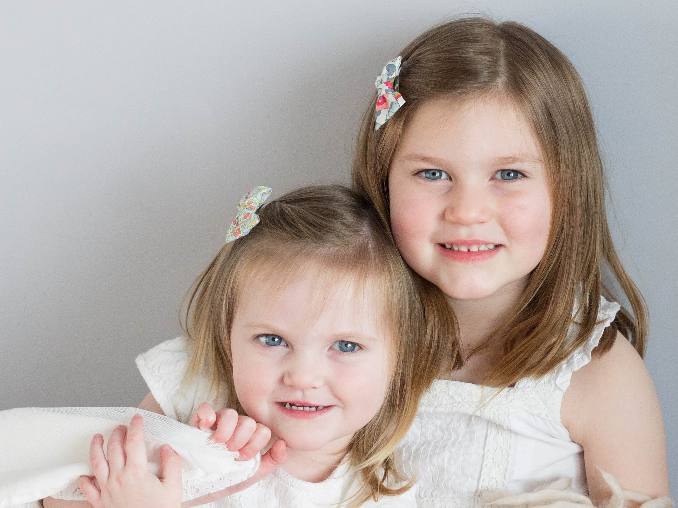 Girl wearing a Liberty London print small bow clip | Holme & Moss