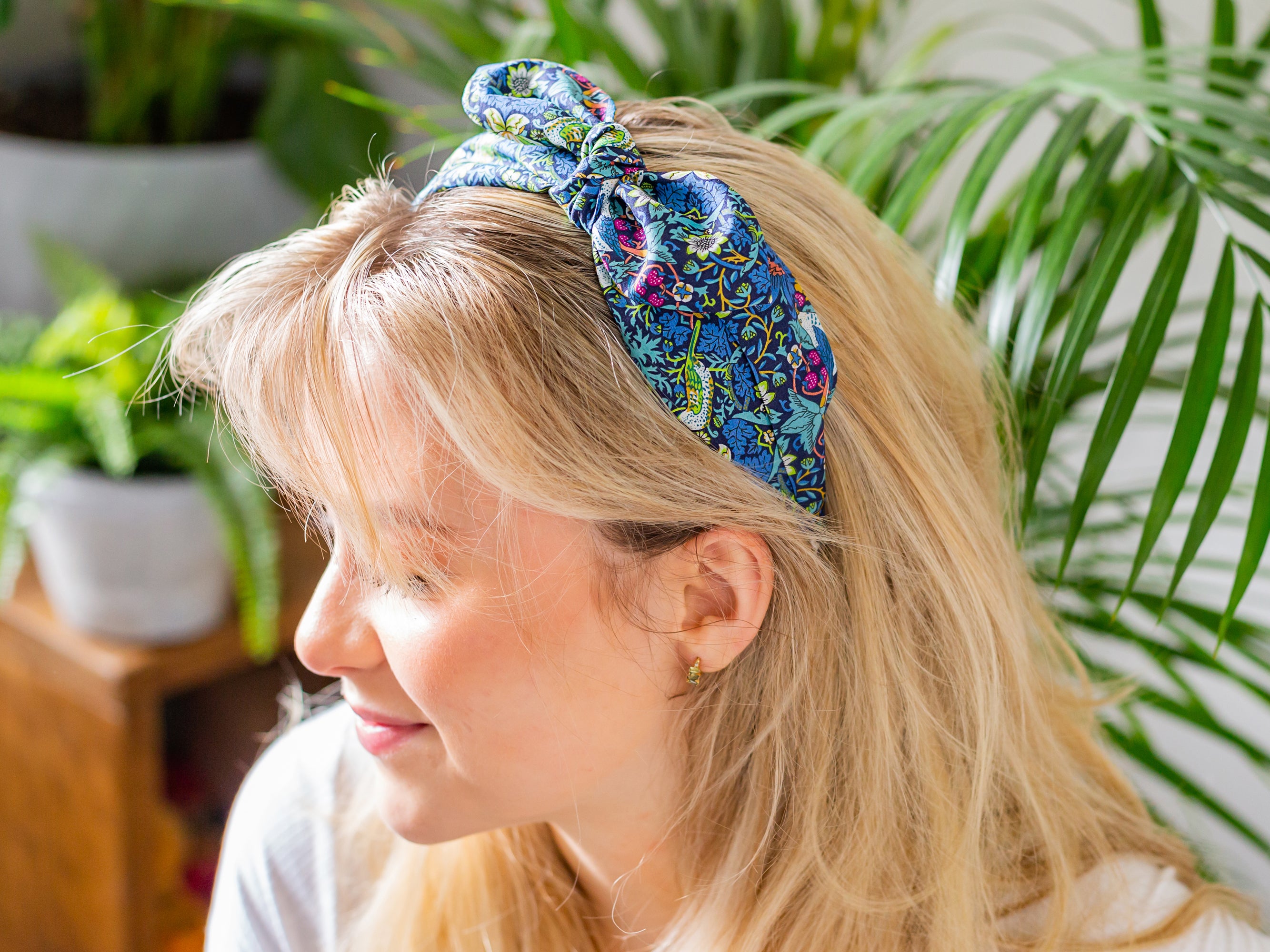 A woman wearing a Liberty London print side bow headband | Holme & Moss