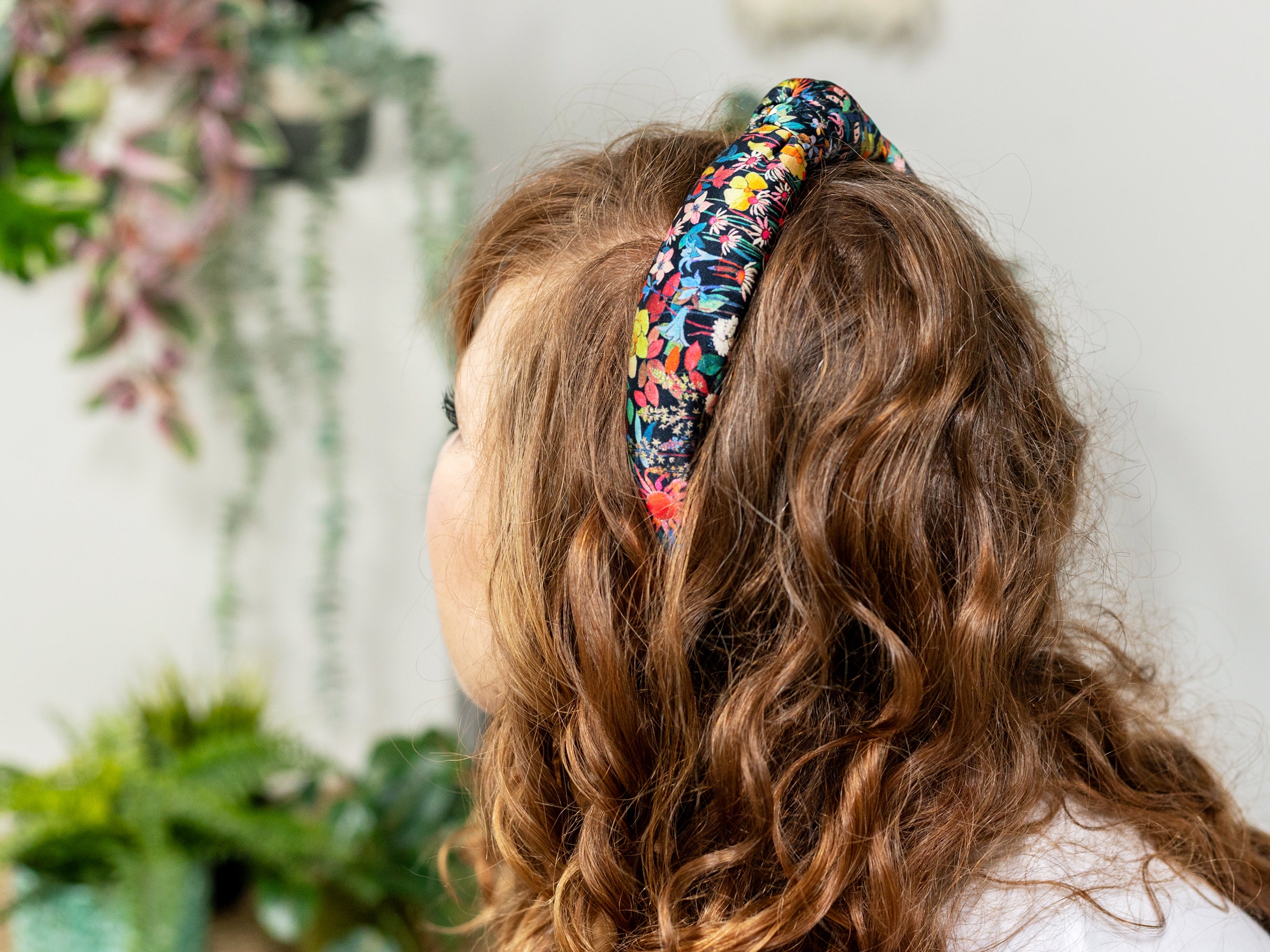 A Model Wearing a Padded Knot Headband, Liberty London Silk Satin Faria Flowers Print | Holme & Moss