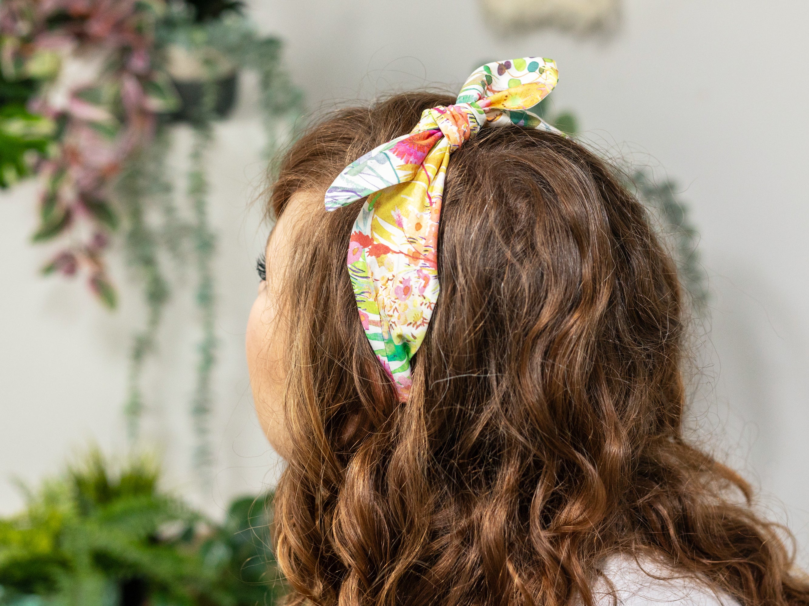 A woman wearing a Liberty London Tresco F print side bow headband | Holme & Moss