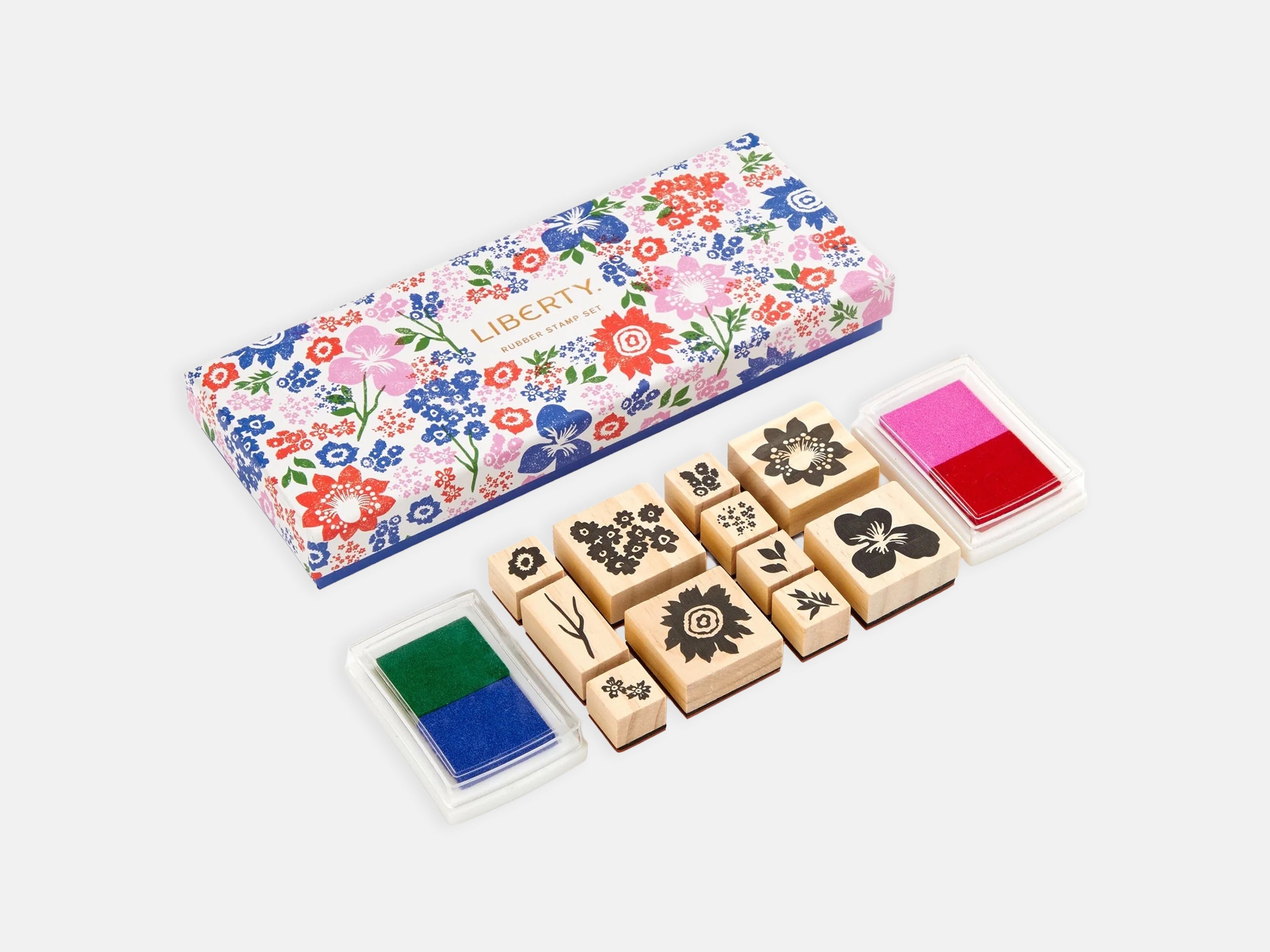 Set of wooden stamps with floral designs and colorful ink pads on a white background | Liberty Rubber Stamp Set | Holme & Moss