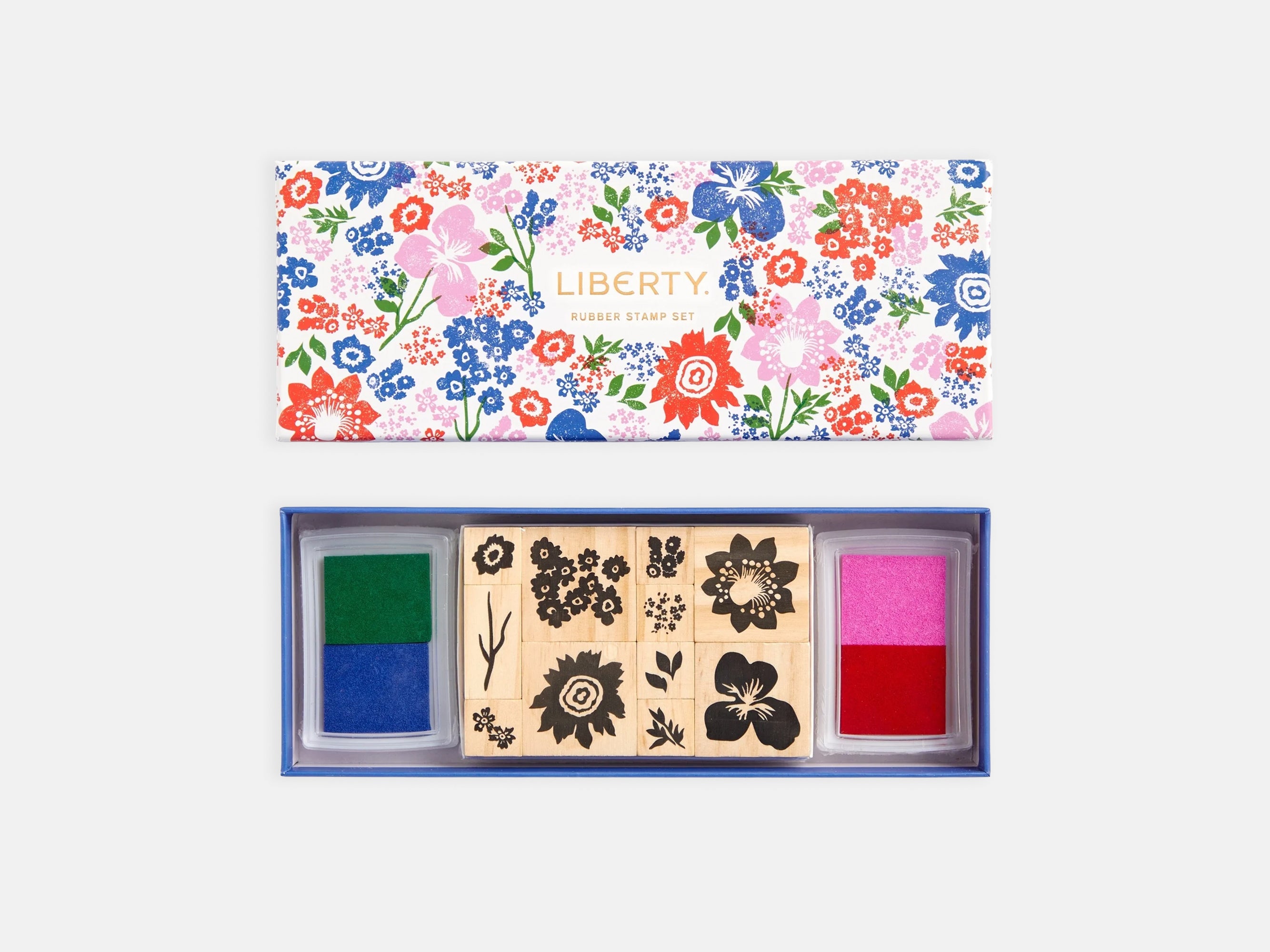 Set of wooden stamps with floral designs and colorful ink pads on a white background | Liberty Rubber Stamp Set | Holme & Moss