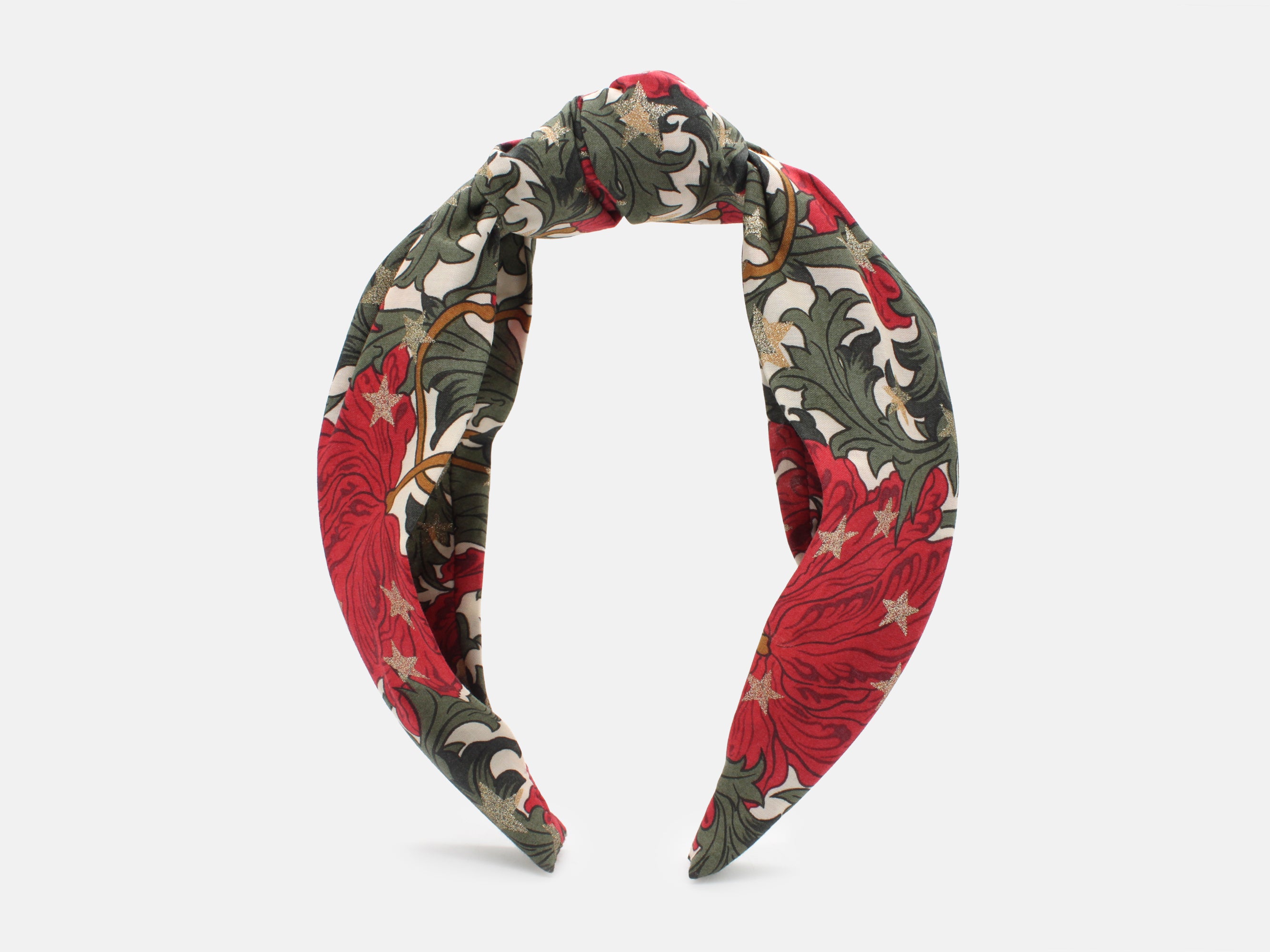 A festive headband in rich red and green, scattered with shimmering gold stars | Classic Knot Headband - Liberty Merry Reverie Print | Holme & Moss
