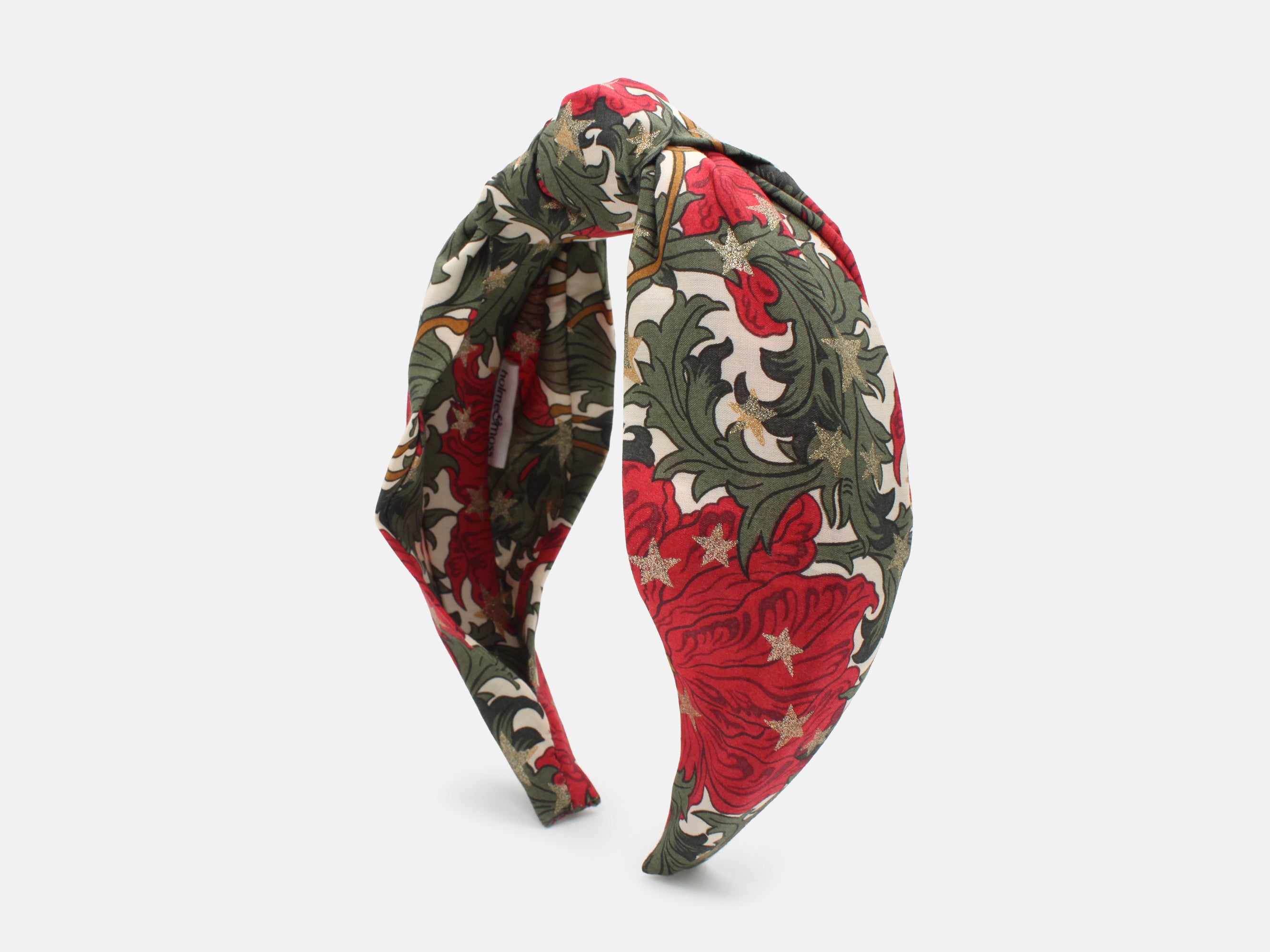 A festive headband in rich red and green, scattered with shimmering gold stars | Classic Knot Headband - Liberty Merry Reverie Print | Holme & Moss