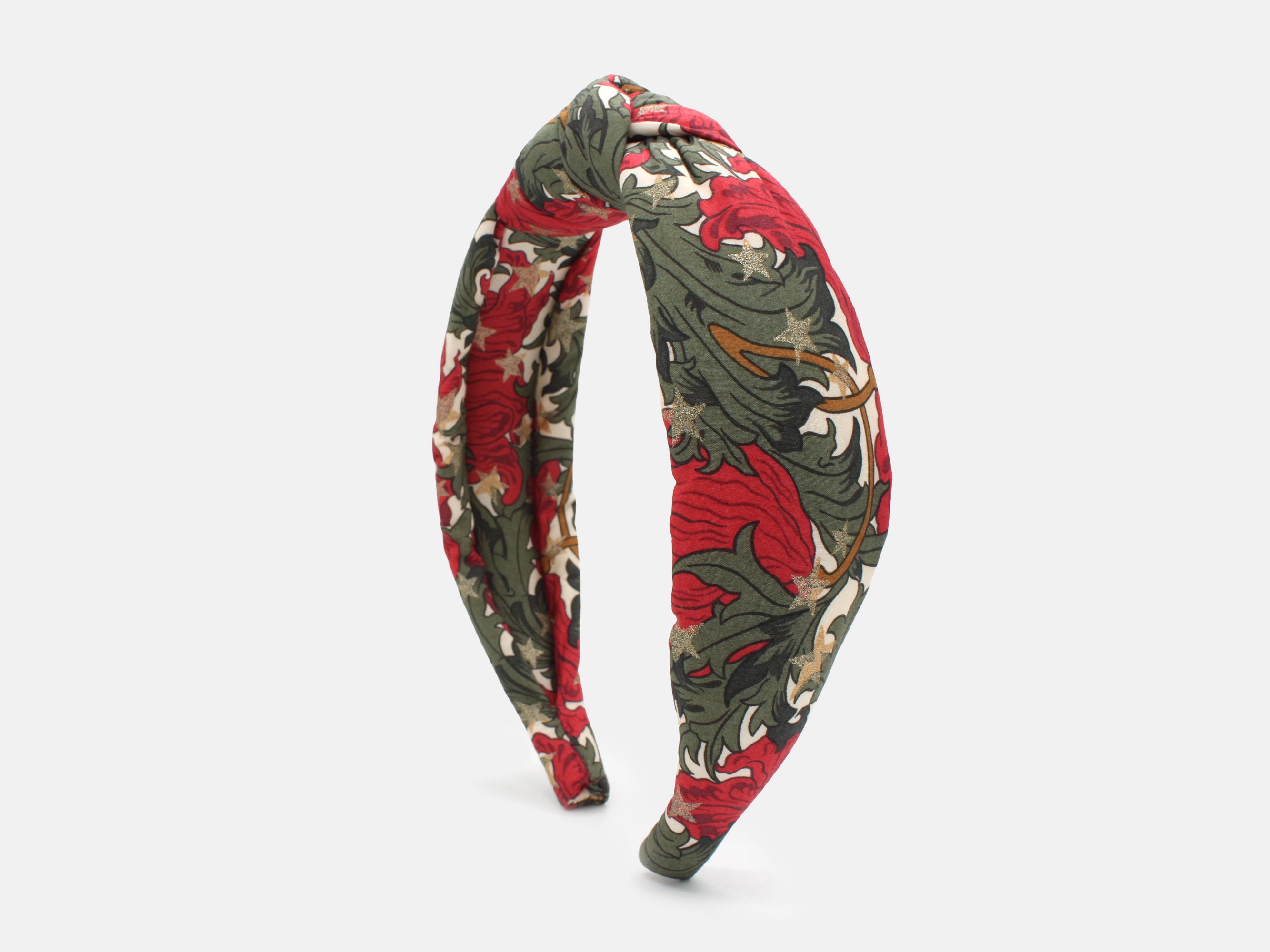 A padded knot headband in rich red and green, scattered with shimmering gold stars | Padded Knot Headband - Liberty Merry Reverie Print | Holme & Moss