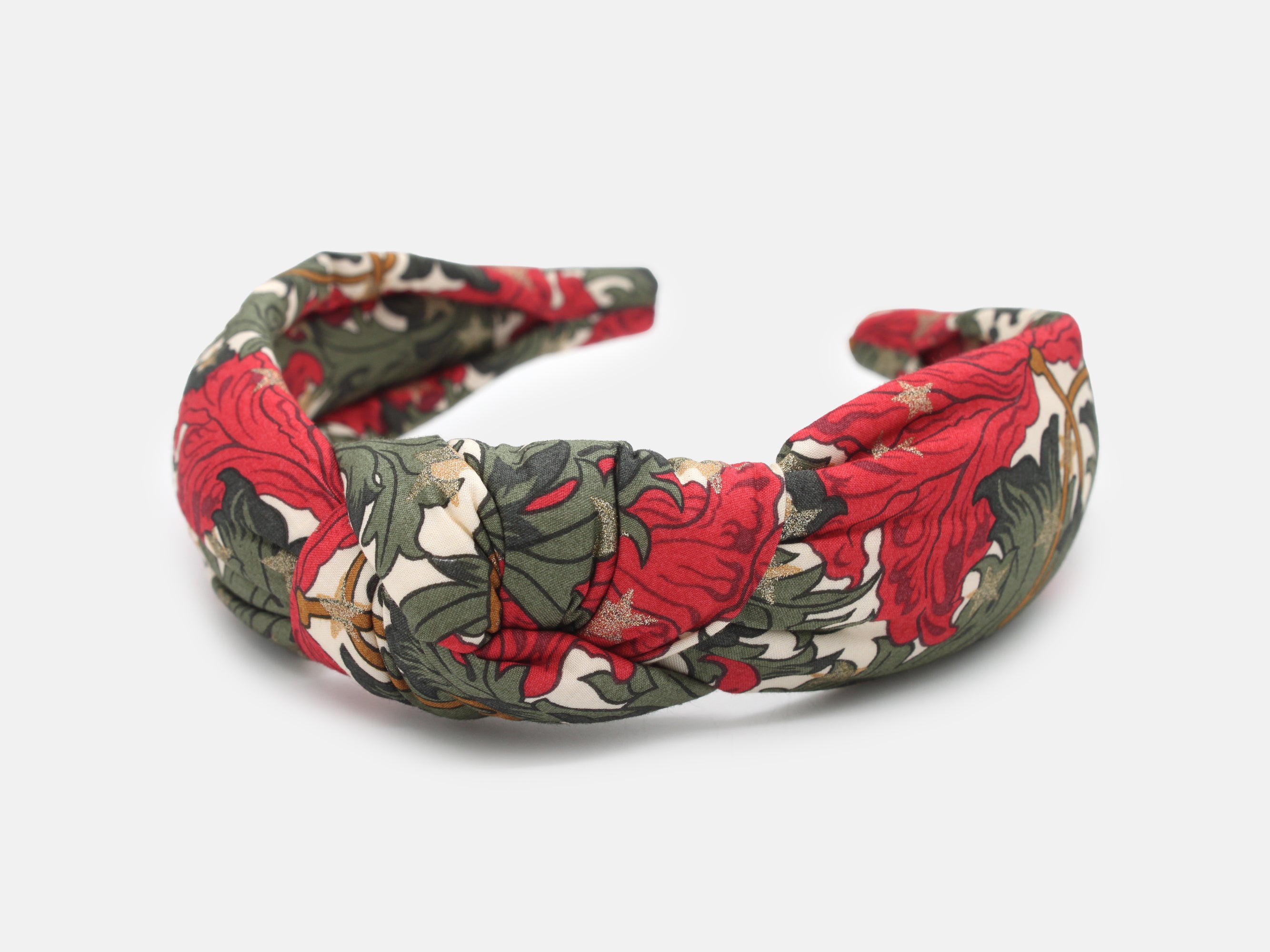A padded knot headband in rich red and green, scattered with shimmering gold stars | Padded Knot Headband - Liberty Merry Reverie Print | Holme & Moss