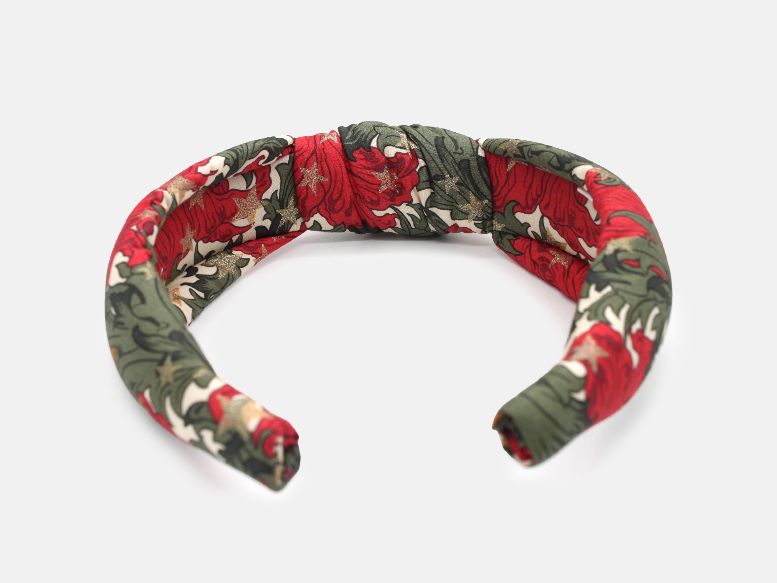 A padded knot headband in rich red and green, scattered with shimmering gold stars | Padded Knot Headband - Liberty Merry Reverie Print | Holme & Moss