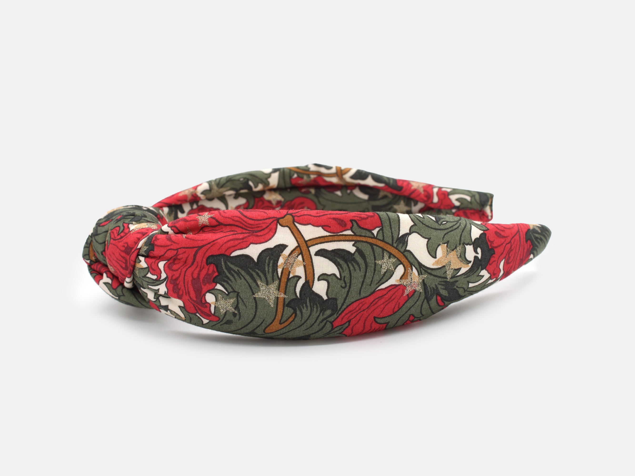A padded knot headband in rich red and green, scattered with shimmering gold stars | Padded Knot Headband - Liberty Merry Reverie Print | Holme & Moss