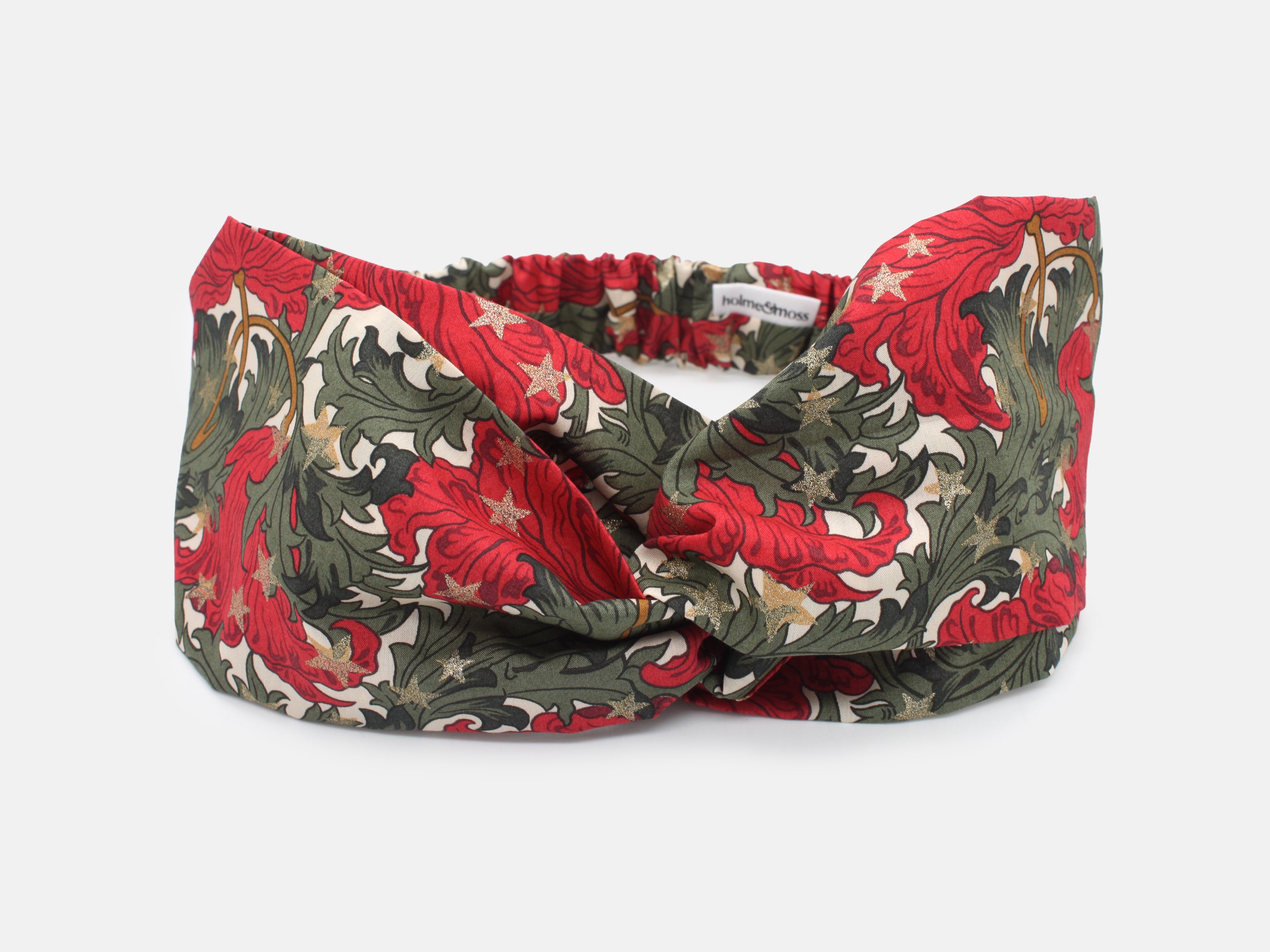 Festive Liberty Fabrics twist headband in rich red and green, scattered with shimmering gold stars | Twist Headband - Liberty Merry Reverie Print | Holme & Moss