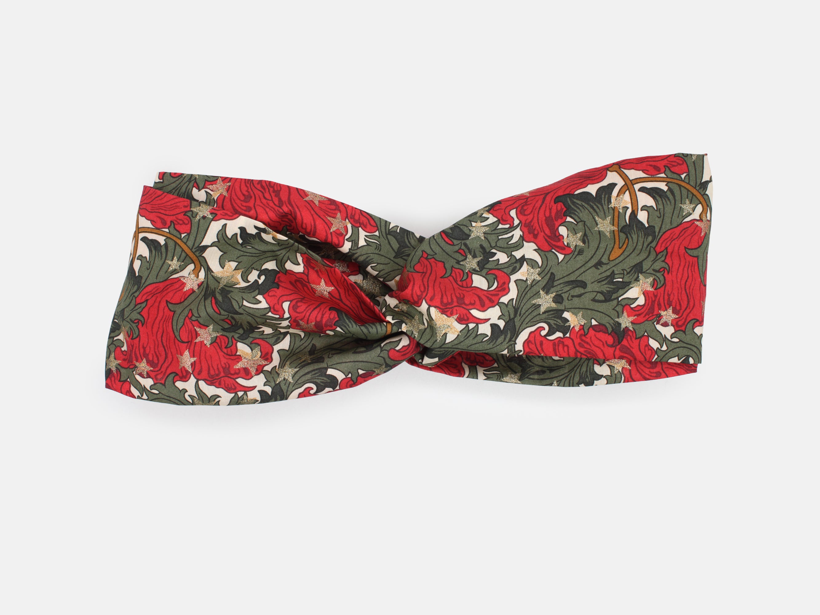 Festive Liberty Fabrics twist headband in rich red and green, scattered with shimmering gold stars | Twist Headband - Liberty Merry Reverie Print | Holme & Moss