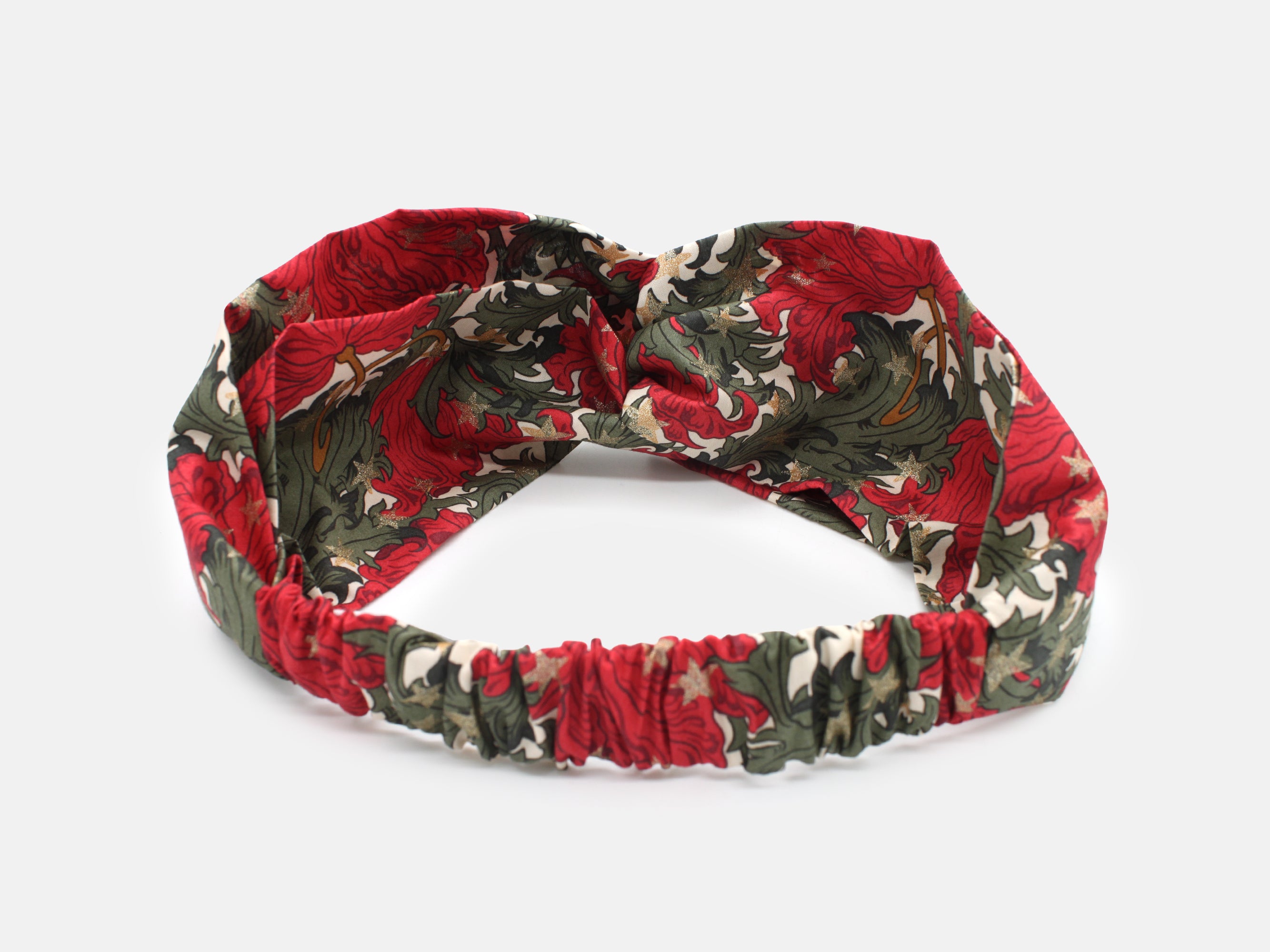 Festive Liberty Fabrics twist headband in rich red and green, scattered with shimmering gold stars | Twist Headband - Liberty Merry Reverie Print | Holme & Moss