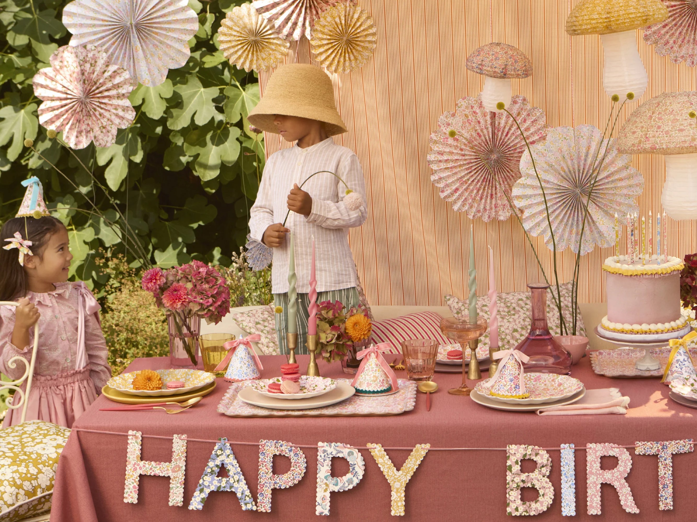 Children at a birthday party with a decorated table and 'Happy Birthday' sign and Liberty paper pinwheel decorations | Meri Meri x Liberty Paper Pinwheel Decorations (6) | Holme & Moss