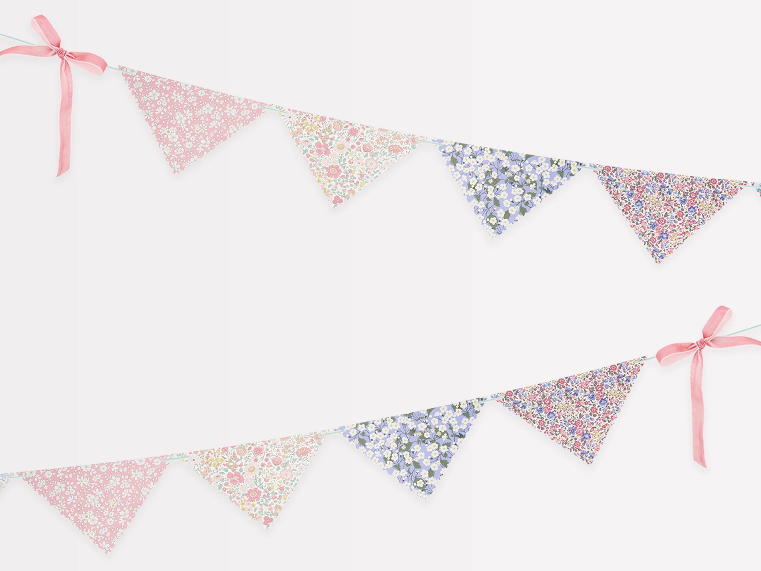 Floral patterned bunting with pink ribbons on a white background | Meri Meri x Liberty Scallop Edge Garland