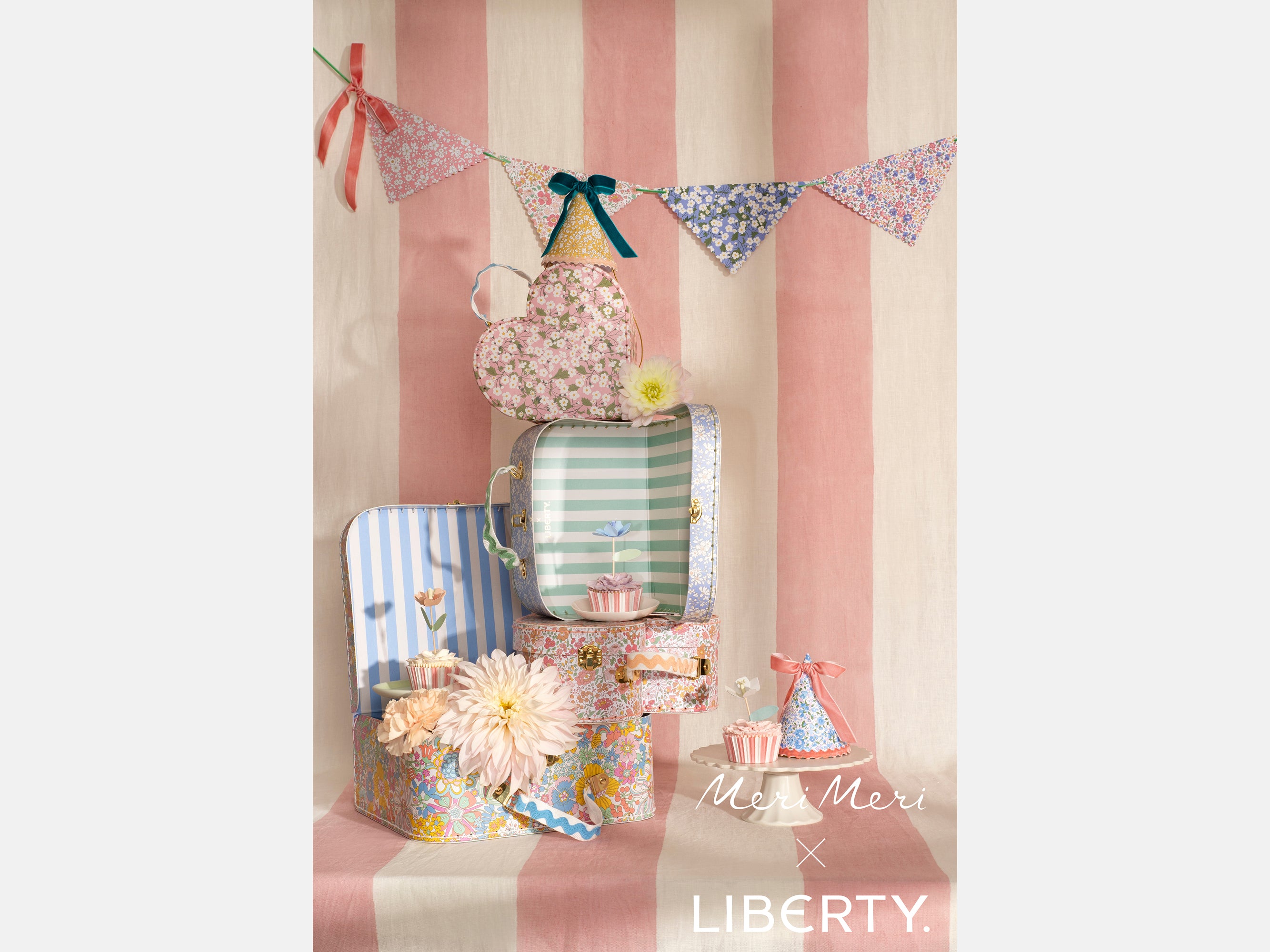 Decorative items including hats and bunting against a striped background with 'Meri Meri' and 'Liberty' logos | Meri Meri x Liberty | Holme & Moss
